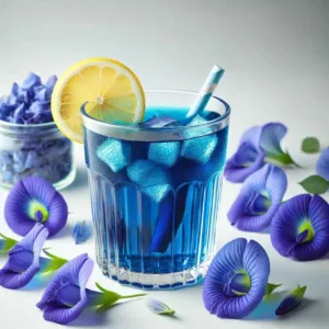 A cup of vibrant blue tea with butterfly pea flowers and a slice of lemon.